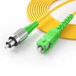 Close-up of SC/APC and FC/APC connectors on simplex fiber patch cable
